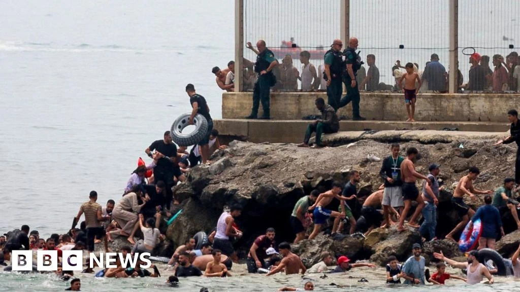 Hundreds of migrants swim from Morocco to Spanish enclave of Ceuta
